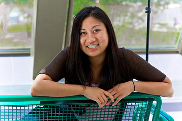 Picture of a Centennial College International Education Student sitting on a bench at progress campus smiling